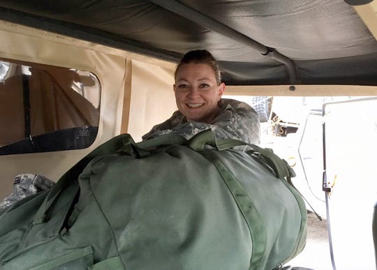 Captain Shelly Rood loading bags into her HMMWV (Humvee) at the end of a training exercise at Camp Grayling, MI, May 2018.