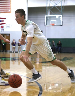 Clear Fork's Brady Tedrow dribbles the ball down the court while playing a home game.