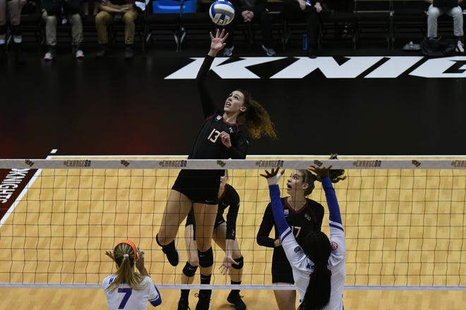 Florida State middle blocker Taryn Knuth (13) goes up to attack against the Florida Gators.
