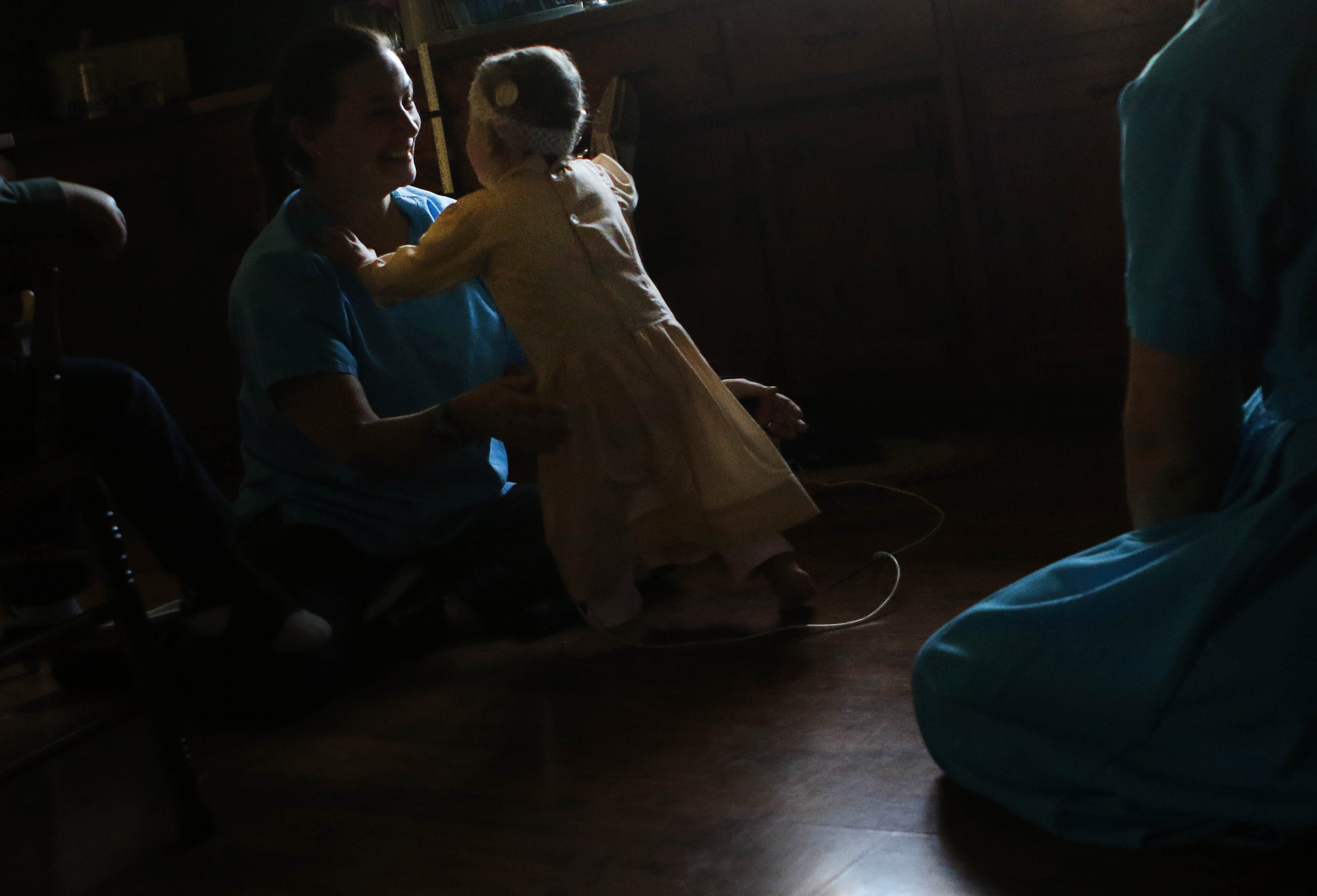 Grace Miller walks toward her physical therapist Cindy Burritt during an at-home physical therapy appointment.