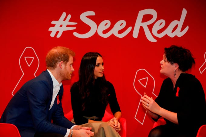 Britain's Prince Harry and his fiancee US actress Meghan Markle gesture as they tour the Terrence Higgins Trust World AIDS Day charity fair at Nottingham Contemporary in Nottingham, central England, on Dec. 1, 2017.