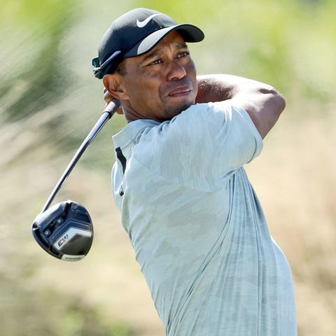 Tiger Woods plays his tee shot on the third hole...