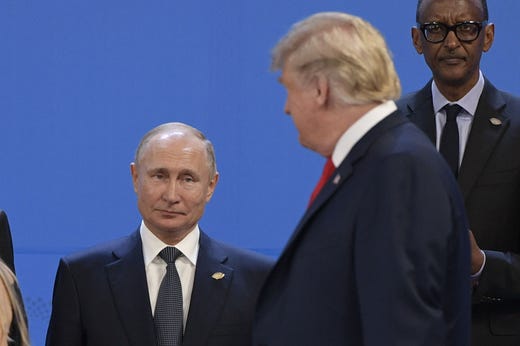 President Donald Trump, right, looks at Russia's President Vladimir Putin as they take place for a family photo, during the G20 Leaders' Summit in Buenos Aires, on Nov. 30, 2018. Global leaders gather in the Argentine capital for a two-day G20 summit beginning on Friday likely to be dominated by simmering international tensions over trade.