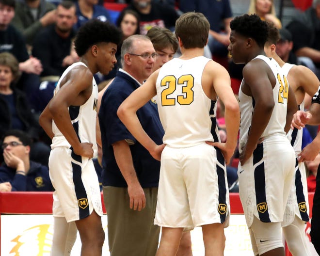 Moeller head coach Carl Kremer talks to his team during a time out at the Ohio Valley Hoops Classic at Hillsboro High School. Moeller defeated Bryan Station 85-42 Dec. 1, 2018.