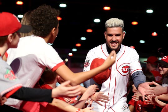 Cincinnati Reds third baseman Eugenio Suarez high-fives fans as he is introduced to the stage during Redsfest.