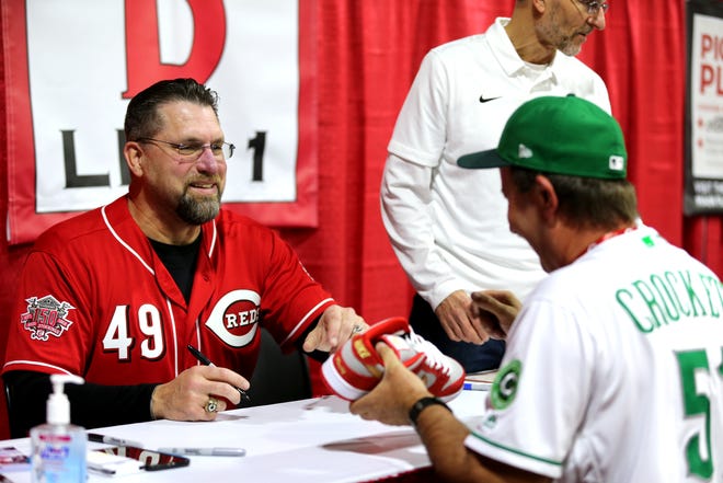 Former Cincinnati Reds pitcher Rob Dibble laughs with a fan during Redsfest on Friday at Duke Energy Convention Center.
