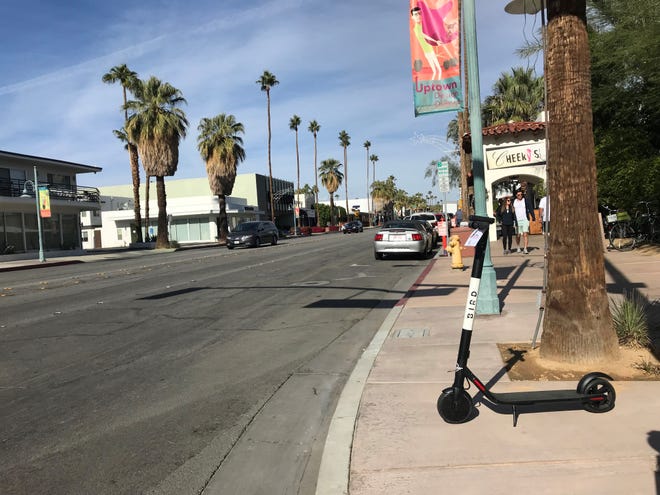 A Bird Scooter sits on Palm Canyon Drive in downtown Palm Springs on Saturday about 12:15 p.m. -- past the city's noon deadline to have them removed.