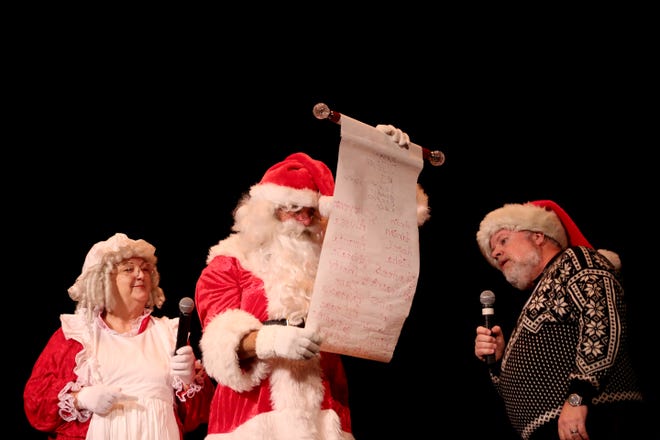 Santa Claus and Mrs. Claus read a list of good names at the children's holiday party at the Elsinore Theatre.