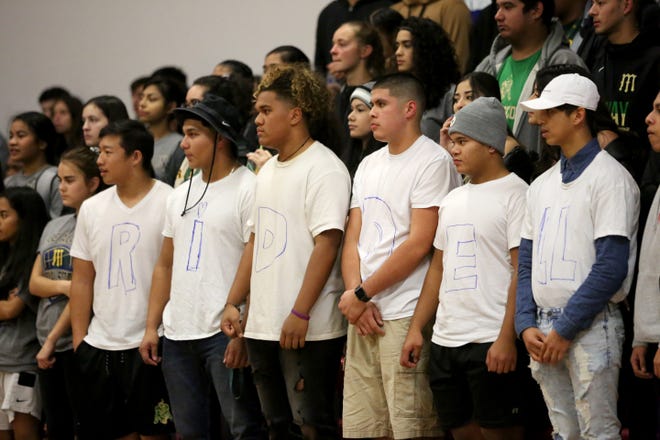 McKay students show support for former football coach Josh Riddell by wearing shirts that spell out his name during their game at North Salem High School on Friday. McKay decided not to bring Riddell back as head coach next season.