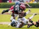 South Carolina running back Mon Denson is upended by Akron linebacker Ulysees Gilbert III in the second half at Williams-Brice Stadium.