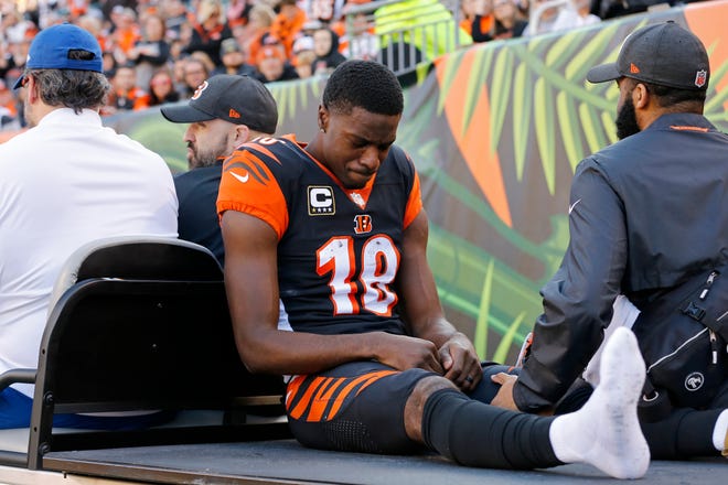 Cincinnati Bengals wide receiver A.J. Green (18) is carted off the field after re-injuring his foot, after missing three games, in the second quarter of the NFL Week 13 game between the Cincinnati Bengals and the Denver Broncos at Paul Brown Stadium in downtown Cincinnati on Sunday, Dec. 2, 2018. The Broncos led 7-3 at halftime. 