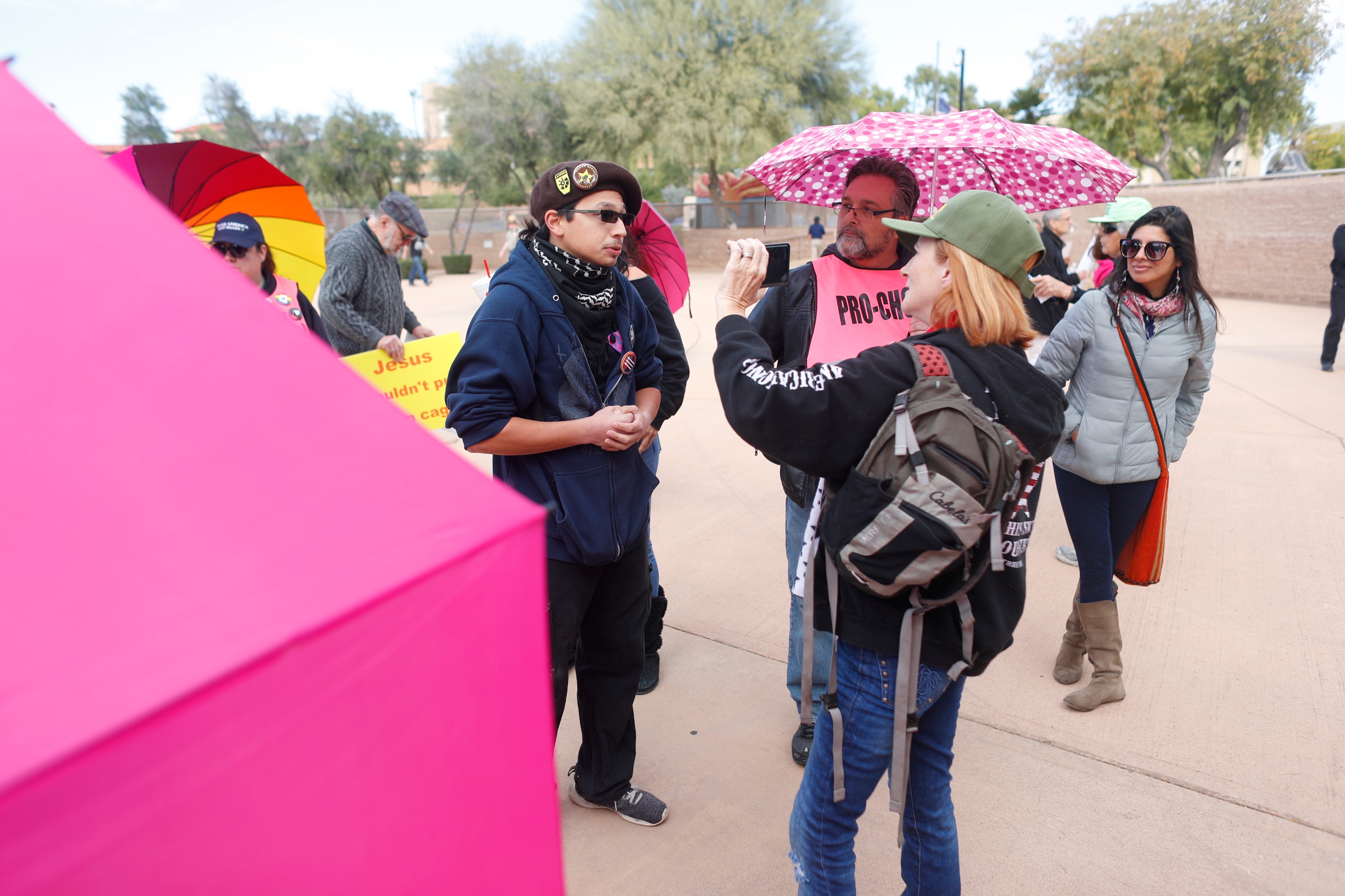 Dillon Williams (left) argues with Lesa Antone of Patriot Movement AZ during a rally at Wesley Bolin Memorial Plaza on Dec. 2, 2018.