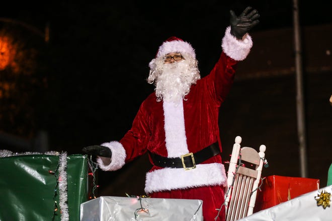 Santa waves to the kids from a float during the Concho Christmas Celebration Parade on Saturday Dec. 1, 2018, in downtown San Angelo.