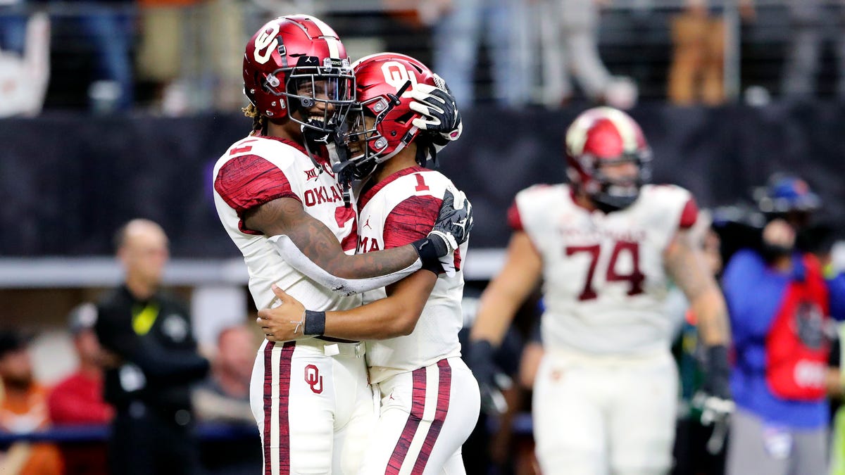Oklahoma quarterback Kyler Murray (1) and wide receiver CeeDee Lamb  celebrate a touchdown during the fourth quarter against Texas in the Big 12 championship game at AT&T Stadium.