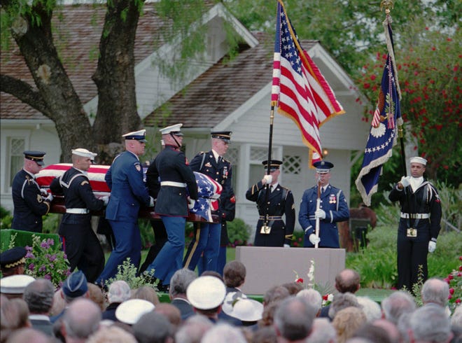 The casket of Richard Nixon is delivered to funeral services by a military honor guard at the Nixon Library in Yorba Linda, Calif., on April 27, 1994. 