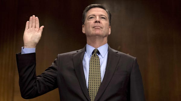 FBI Director James Comey is sworn in prior to...
