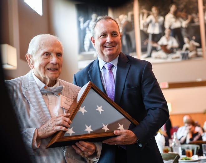 In 2017, Clemson graduate Col. Ben Skardon, left, is presented a a flag flown over the U.S. Capitol by U.S. Rep. Jeff Duncan, right, during his 100th birthday celebration at the Brooks Center in Clemson.