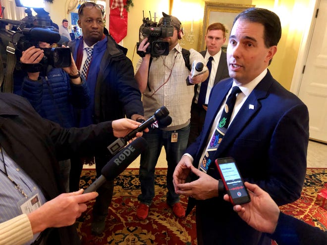 Gov. Scott Walker tells reporters Monday he doesn't believe the Republican plan that changes powers of Gov.-elect Tony Evers and Attorney General-elect Josh Kaul is overreaching.