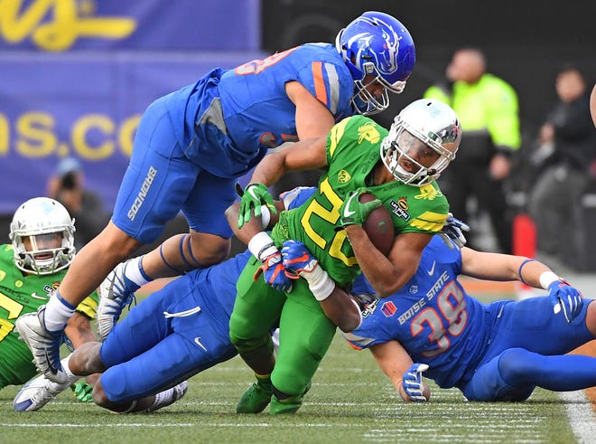 Dec 16, 2017; Las Vegas, NV, USA; Oregon running back Tony Brooks-James (20) is knocked out of bounds by Boise State linebacker Tyson Maeva (58) during the second half of the 2017 Las Vegas Bowl at Sam Boyd Stadium. Boise State won 38-28.