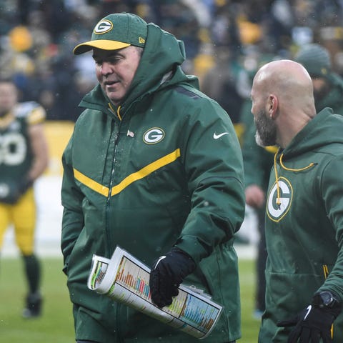 Green Bay Packers head coach Mike McCarthy walks...