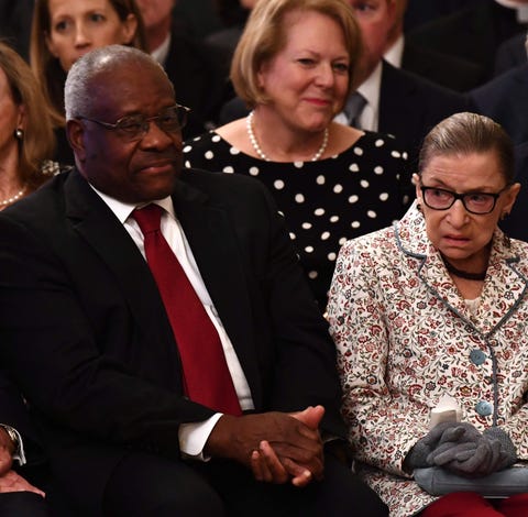 Supreme Court Justices Clarence Thomas and Ruth...