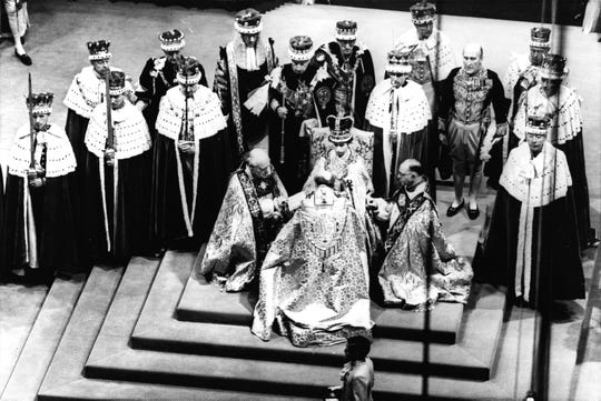 The coronation on June 2, 1953 of Queen Elizabeth II, seated on her throne and surrounded by bishops in Westminster Abbey, London.