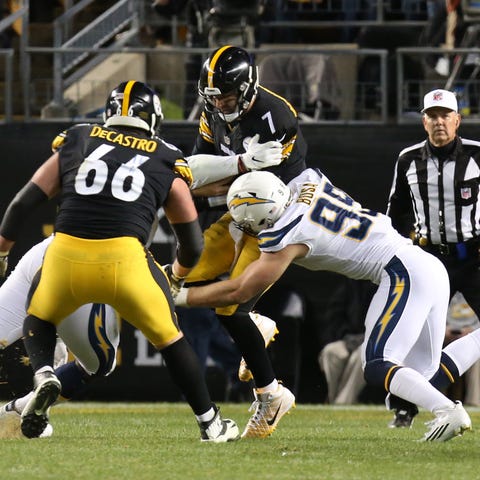 Chargers defensive tackle Justin Jones (left) and...