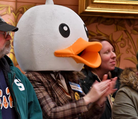 Chanting demonstrators, including a man wearing duck head and a 'Lame Duck' name tag, jam the second floor of the Rotunda at the Michigan State Capitol building on Tuesday, December 4, 2018, protest legislation being considered in the "Lame Duck" sessions of the House and Senate.