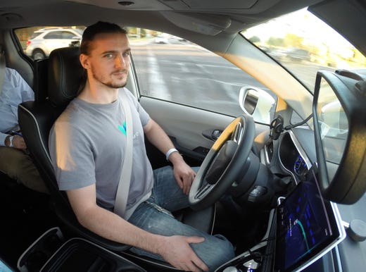 Waymo Safety driver Derek Sirakis monitors a self-driving car Nov. 28, 2018, during a demonstration ride in Chandler, Ariz. Tempe, Mesa, Chandler and Gilbert will be the first cities in the world with Waymo One self-driving service.