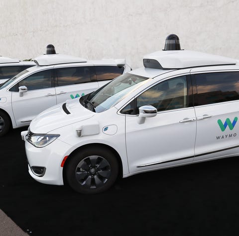 Waymo self-driving cars are seen Nov. 28, 2018,...