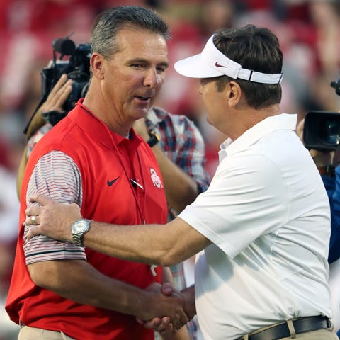 Ohio State coach Urban Meyer, left, shakes hands w