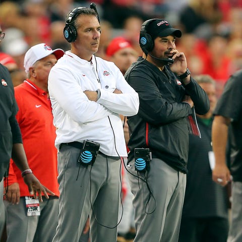 Ohio State coach Urban Meyer, left, stands with...