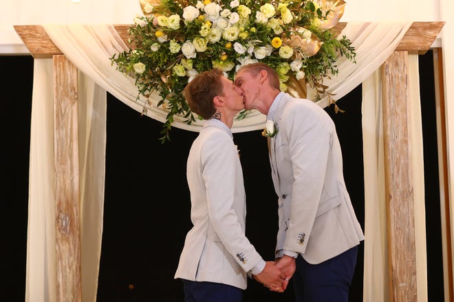 Craig Burns and Luke Sullivan kiss during the wedding ceremony after  Australian Marriage Act became legal