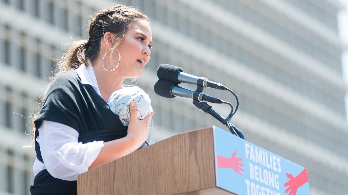 Chrissy Teigen holds baby Miles while speaking onstage at 'Families Belong Together  - Freedom for Immigrants March on June 30, 2018 in Los Angeles.