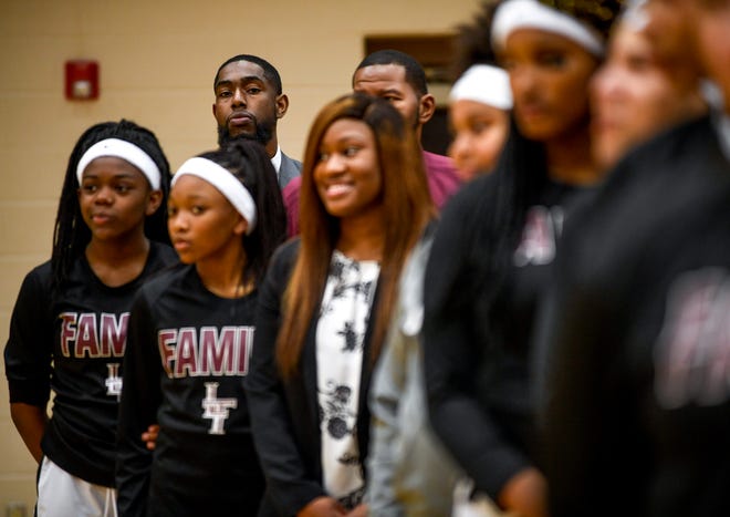 Liberty head coach Aaron Woods looks down a row of his players during a moment of silence for Nyema Jackson, the mother of Liberty starting point guard Nyjah Jackson, who was killed in a car wreck while being transported to a hospital in an ambulance over the weekend, at a TSSAA girls basketball game where Liberty played Ripley High School at Liberty Tech High School in Jackson, Tenn., on Tuesday, Dec. 4, 2018. 