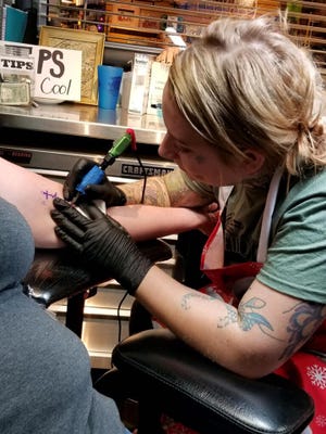 Artist Amanda Herren helped come up with the idea to raise money for Foster Adopt Connect and Sammy's Window. She and the other artist at Kaleidoscope Ink worked from 10 a.m. to 9 p.m. Tuesday, Dec. 4, and gave 149 tattoos for their fundraiser.
