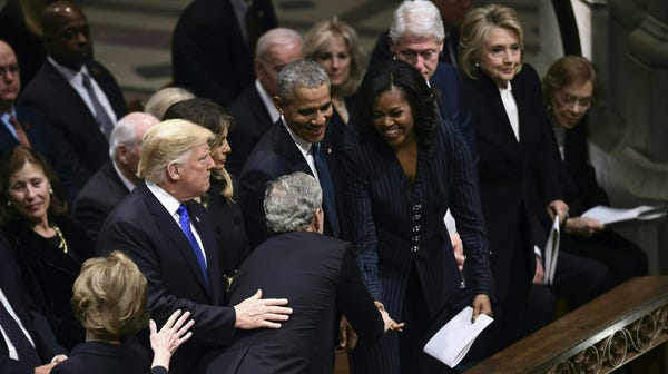 Former president George W. Bush (C), flanked by...