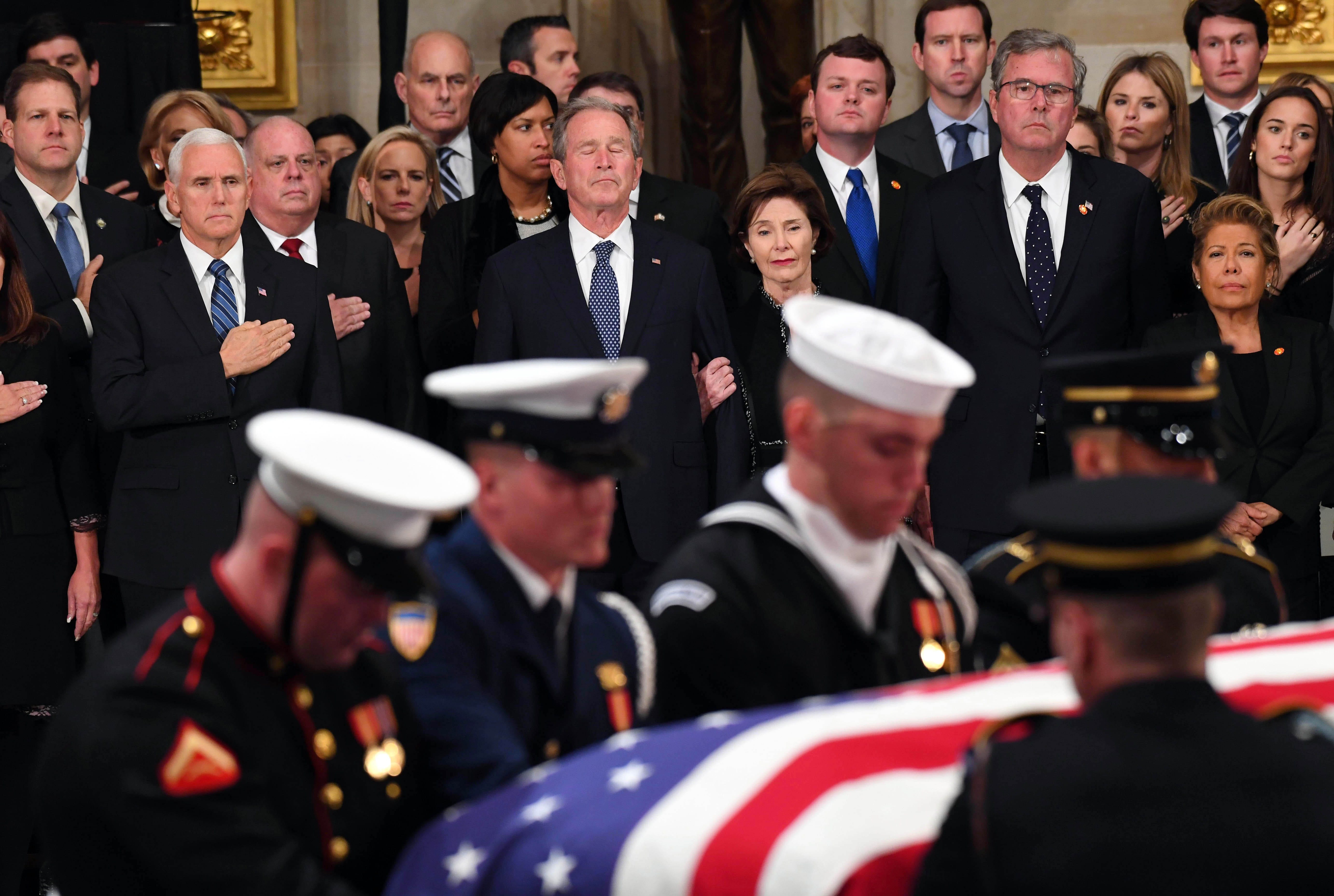 Former President George W. Bush and his wife Laura Bush look on as Former President George H.W. Bush arrives to lie in state at the U.S. Capitol Rotunda on Dec. 3, 2018 . Since President Washington's death, the loss of one of its former leaders has united America in a way few other events can. Americans tend to put political animosity aside and to momentarily forgive a president's faults, to honor the fallen leader and to celebrate the shared history reflected in his time in office.