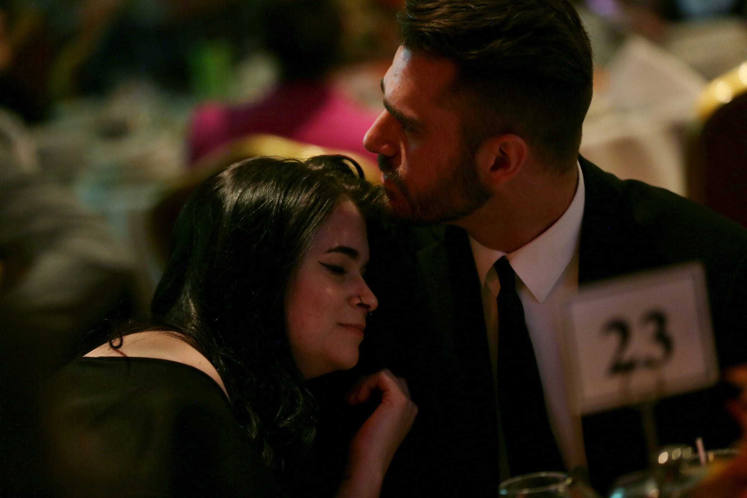 Justin Newman, 29, right who is part of drug treatment court at 41B District Court in Clinton Township gets a hug from his girlfriend after sharing part of his journey through opioid addiction during the 8th Annual Families Against Narcotics Fall Fest dinner fundraiser at Penna's of Sterling Heights.