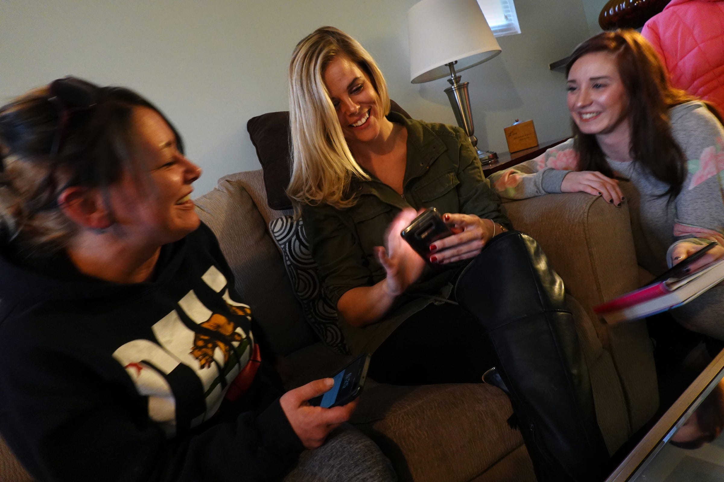 Megan Ferranti, from left peer recovery coach Amy Wilson and Jessica Dover share a laugh during one of their regular meetings at the 3/4 house they live at in Roseville