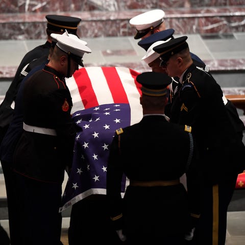 The flag-draped casket of former President George...