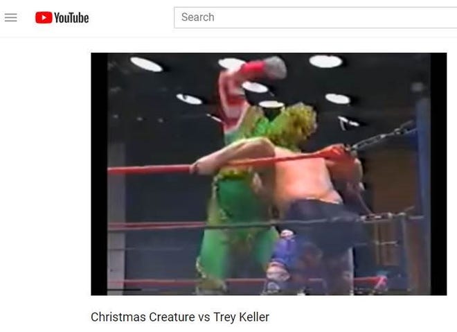In this screenshot from a 1992 USWA match, Glenn Jacobs (left) wrestles as the Christmas Creature prior to becoming the Kane character in the WWF.