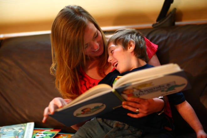 Babysitter Samantha McLeod reads with 5 year old Brian Quayle at the Quayle home.