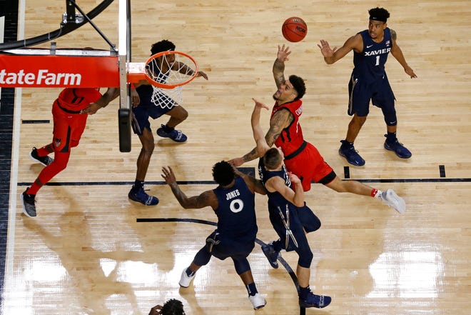 Cincinnati Bearcats guard Jarron Cumberland (34) throw up a shot in the second half of the 86th Annual Crosstown Shootout basketball game between the Cincinnati Bearcats and the Xavier Musketeers at UC's Fifth Third Arena in Cincinnati on Saturday, Dec. 8, 2018. The Bearcats won the city rivalry game 62-47.