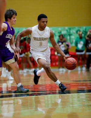 Warren Central High School's Manuel Brown (3) dribbles past Cathedral High School's Ryan Trusler (4) during a varsity boys basketball game between Cathedral High School and Warren Central High School at Warren Central on Friday, Dec. 7, 2018.