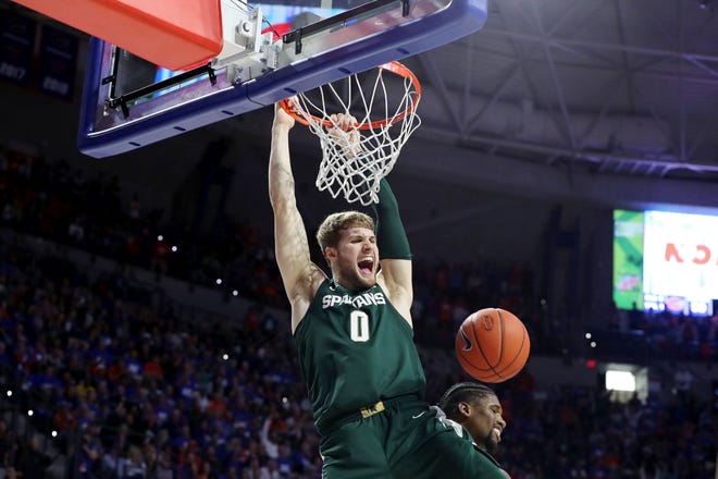USA;Michigan State Spartans forward Kyle Ahrens (0) celebrates as he dunks against the Florida Gators during the second half at Exactech Arena.