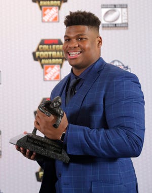 Alabama's Quinnen Williams poses with the trophy after winning the Outland Trophy as the nation's best interior lineman in college football, Thursday, Dec. 6, 2018, in Atlanta. (AP Photo/John Bazemore)