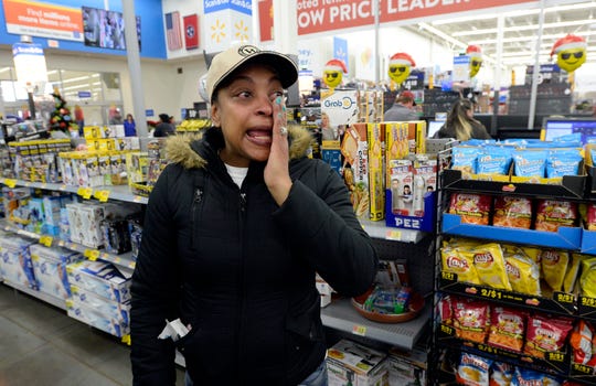 Kenya Sanders wipes tears away as she heads to pick up the Christmas gifts she had on layaway at a Walmart store on Saturday, Dec. 8, 2018, in Nashville, Tenn. Kid Rock spent about $81,000 Saturday to pay off the balances of 350 layaway accounts, including the one belonging to Sanders, at the Dickerson Pike store.