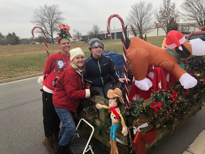 From left to right: Sara Miller, Susan Miller and Caleb Stewart with their family float for the Stuarts Draft Christmas Parade on Dec. 8, 2018.