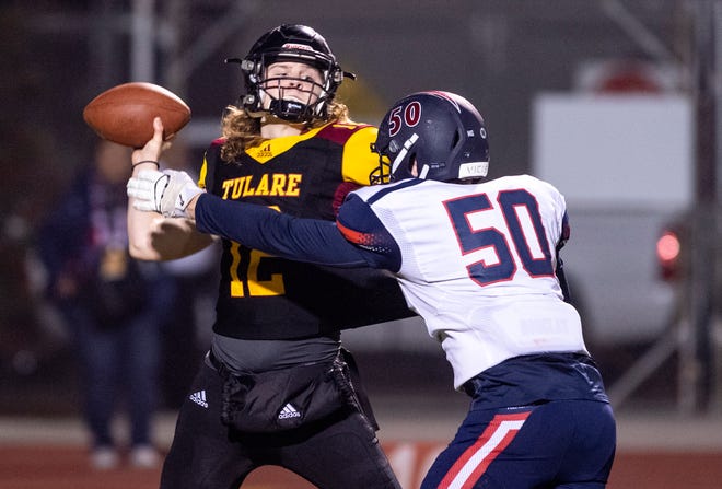 Tulare Union's Nathan Lamb passes under pressure from San Joaquin Memorial's Justin Hunt during a CIF State Northern California Division 2-A Regional Bowl Game at Mathias Stadium on Saturday, December 8, 2018.